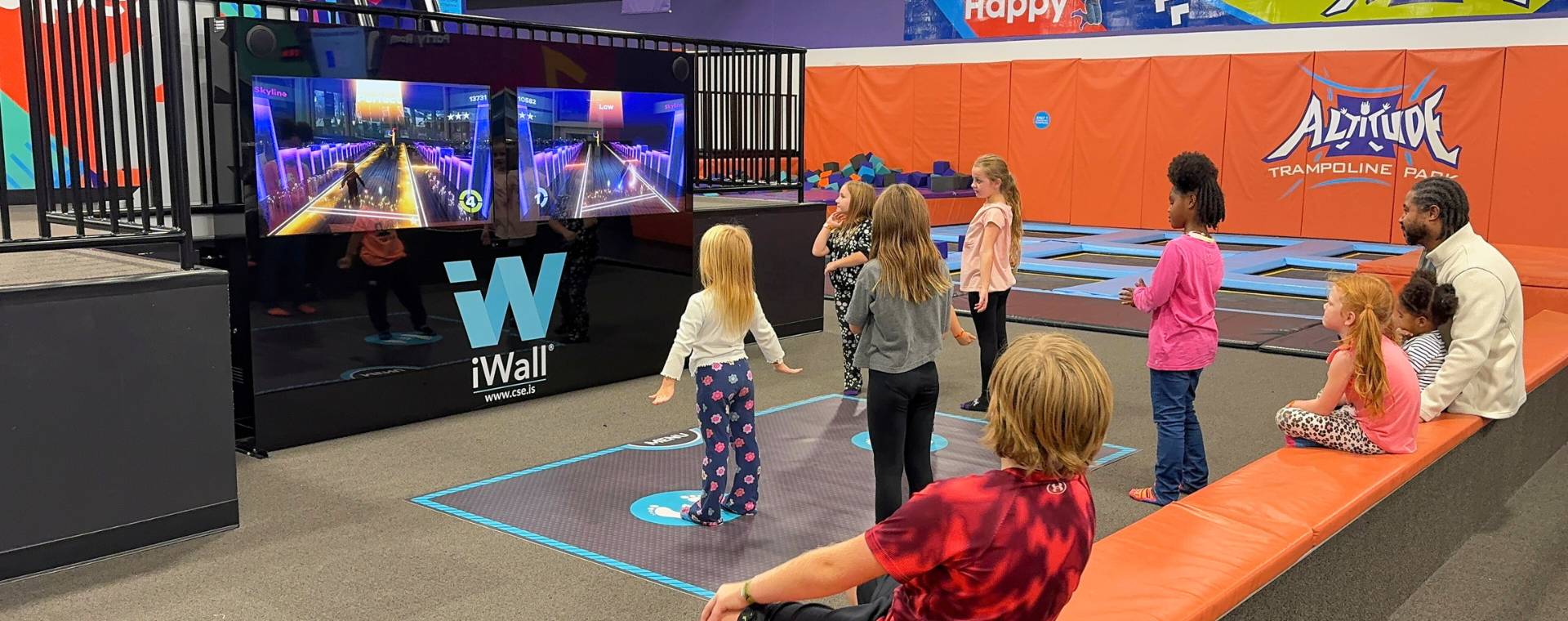 Two girls interact with a iWall at SuperPark.