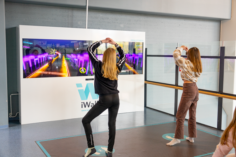 Multible girls playing iWall in school